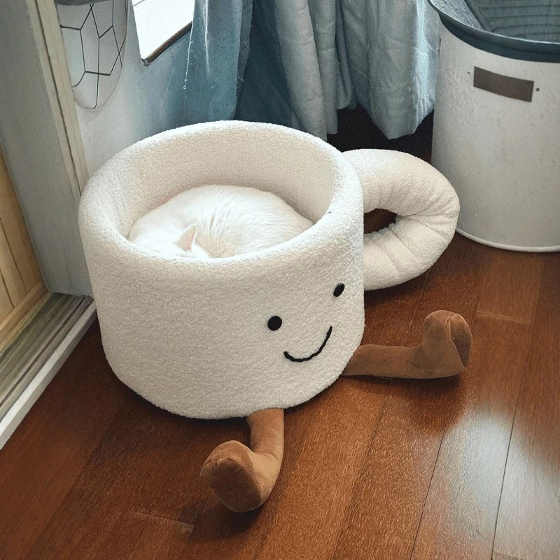 Full view of the unique oversized white coffee mug cute cat bed with a smiling face and plush brown legs.